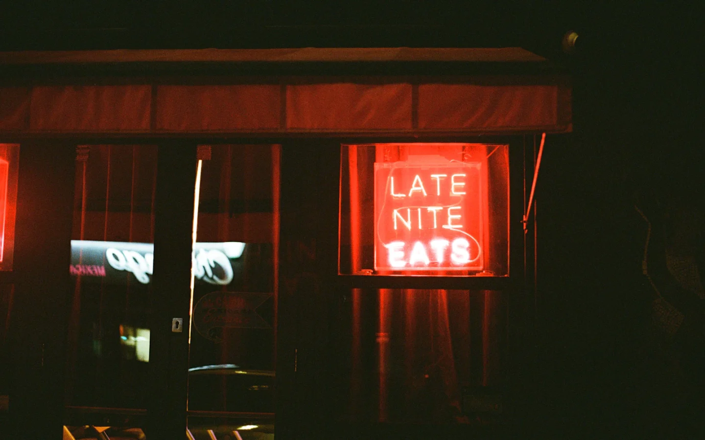 Biển neon Late Night Eats nổi bật giữa bóng tối